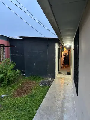 a hallway of a house with a black wall at Perezoso View Apartment in Guápiles