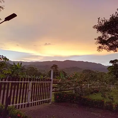 a fence with a view of the mountains at Cabinas MaWa Tropical 5 minutos a playa in Uvita