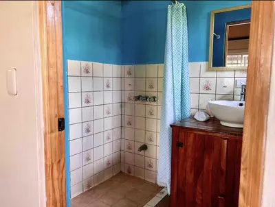 a bathroom with a sink and a mirror at Mi Zaru Sea View Hotel Free Park Tour & Breakfast in Manuel Antonio