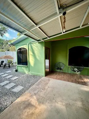 a green house with a flat screen tv on a patio at House with a private swimming pool in Chontales