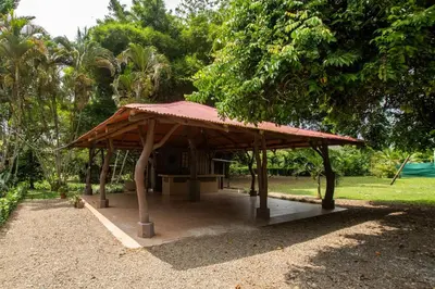 a pavilion with a red roof in a park at Casa del Lago in Repunta