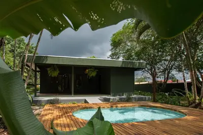 a swimming pool in front of a house at Casa del Lago in Repunta