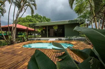 a swimming pool in front of a house at Casa del Lago in Repunta