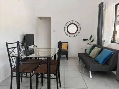 a living room with a table and a couch at Casa Celeste Rio Grande #2 in Puntarenas