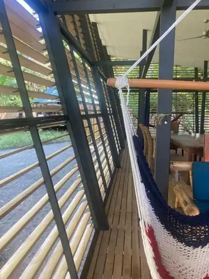 a hammock on the deck of a boat at Awarded No Footprint House on Matapalo Beach in Savegre