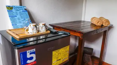 a table on top of a refrigerator with a table on top at Rio Celeste Cabinas Vista Tenorio in El pilon