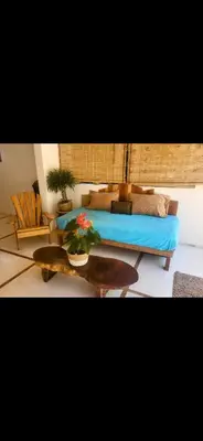 a living room with a bed and a table at Casa joy costa rica in Mal País