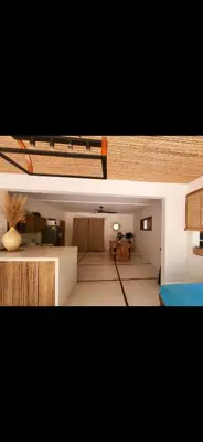 two pictures of a room with a living room at Casa joy costa rica in Mal País