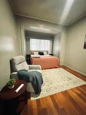 a bedroom with a bed and a couch and a chair at Venus Home in Guápiles