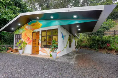 a small house with a painting on the side of it at Coco Cabana in the Jungle in Sarapiquí