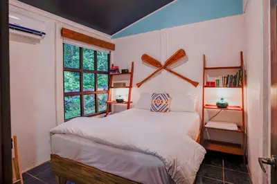 a bedroom with a bed and a window at Coco Cabana in the Jungle in Sarapiquí