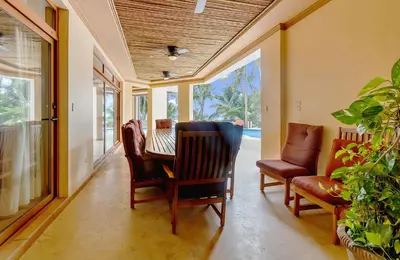 a dining room with a table and two chairs at Palacio Tropical- Secluded & Private Beach in Puntarenas