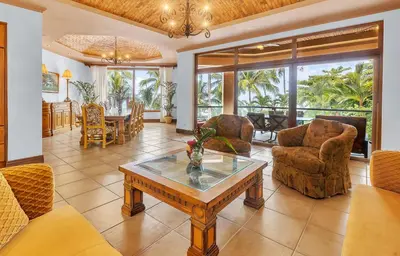 a living room with a table and chairs at Palacio Tropical- Secluded & Private Beach in Puntarenas