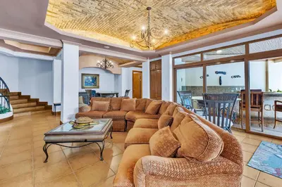 a living room with a couch and a table at Palacio Tropical- Secluded & Private Beach in Puntarenas