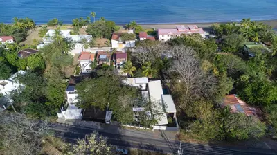 an aerial view of a house next to the ocean at Z102 Studios, 4 Industrial Beach Condos w Pool! in Playa Flamingo