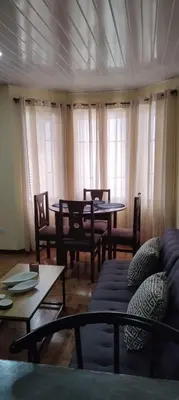 a living room with a couch and a table and chairs at Capi-Capi Retreat in Paquera