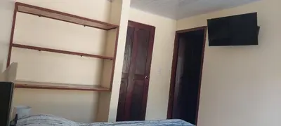 a bedroom with a bed and a television on the wall at Capi-Capi Retreat in Paquera