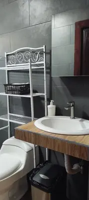a bathroom with a sink and a toilet at Capi-Capi Retreat in Paquera