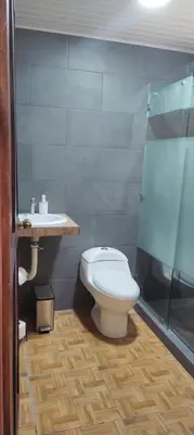 a bathroom with a toilet and a sink at Capi-Capi Retreat in Paquera