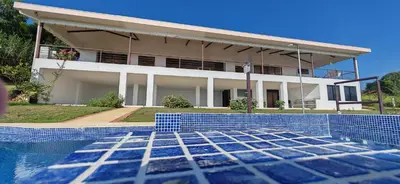 a house with a swimming pool in front of it at Home in Perez Zeledon with Chirripó Views in Angostura
