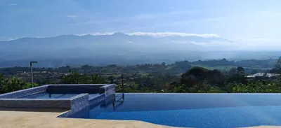 a swimming pool with a view of a mountain at Home in Perez Zeledon with Chirripó Views in Angostura