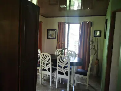 a dining room with a table and chairs at Casa Tucan in Aguas Zarcas