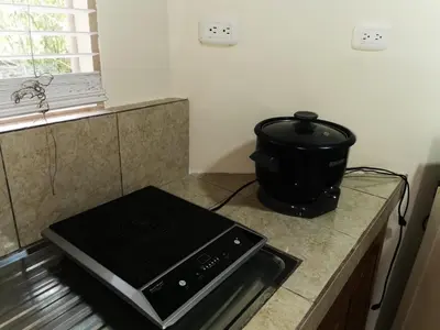 a stove top oven sitting on a counter in a kitchen at Casa Tucan in Aguas Zarcas