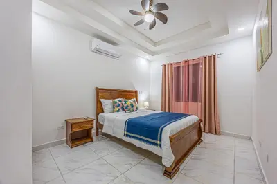 a bedroom with a bed and a ceiling fan at Casa Paraiso de Ballenas in Uvita
