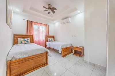 a bedroom with two beds and a window at Casa Paraiso de Ballenas in Uvita