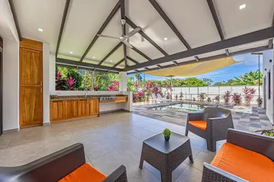 an open living room with a view of a patio at Casa Paraiso de Ballenas in Uvita