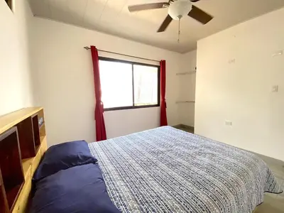a bedroom with a bed with a ceiling fan and a window at Casa Daniela, Relax and Enjoy! in Escobal