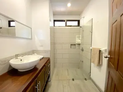 a white bathroom with a sink and a shower at Casa Daniela, Relax and Enjoy! in Escobal