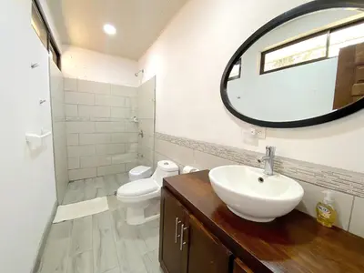 a bathroom with a sink and a toilet and a mirror at Casa Daniela, Relax and Enjoy! in Escobal