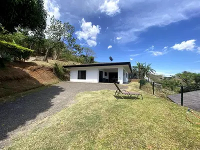 a bench sitting in front of a white house at Casa Daniela, Relax and Enjoy! in Escobal
