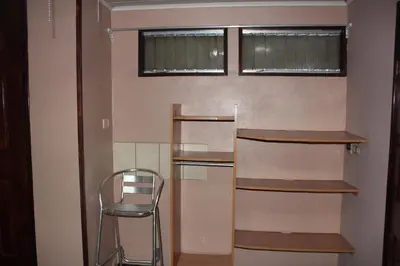 a empty room with a chair and shelves at Hotel El Dorado in San José