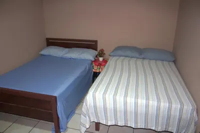 two beds sitting next to each other in a bedroom at Hotel El Dorado in San José