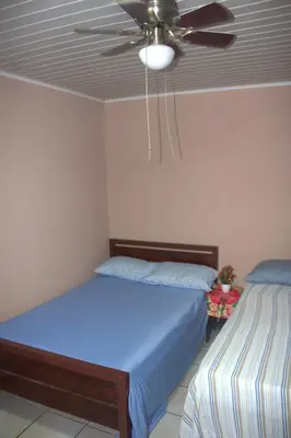 a bedroom with a bed and a ceiling fan at Hotel El Dorado in San José