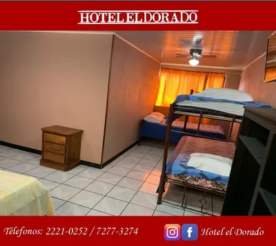 a room with two bunk beds and a table at Hotel El Dorado in San José