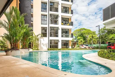 a swimming pool in front of a building at Torres del Mar oceanview 6th-floor two-bedroom condo in Jacó