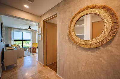 a large mirror on the wall of a living room at Torres del Mar oceanview 6th-floor two-bedroom condo in Jacó