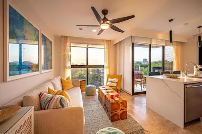 a living room with a couch and a kitchen at Torres del Mar oceanview 6th-floor two-bedroom condo in Jacó