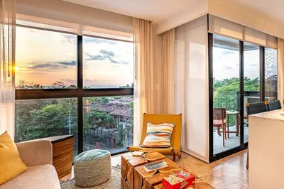 a living room with a couch and a large window at Torres del Mar oceanview 6th-floor two-bedroom condo in Jacó