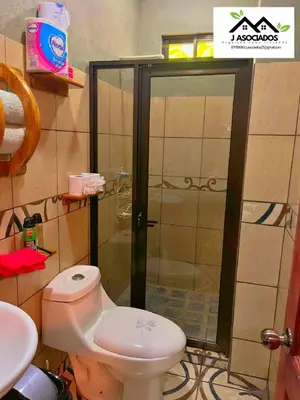 a bathroom with a shower with a toilet and a sink at Casa SAMY in Uvita