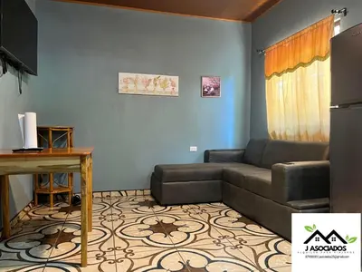 a living room with a couch and a table at Casa SAMY in Uvita