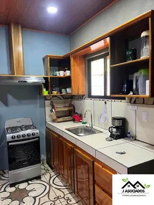 a kitchen with a stove and a sink at Casa SAMY in Uvita