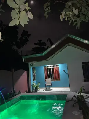 a house with a swimming pool at night at Villa Jade La Fortuna, Family in Fortuna