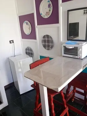 a dining room with a table and two chairs at Kristel Rooms in Quepos