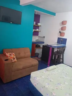 a living room with a couch and a table at Kristel Rooms in Quepos