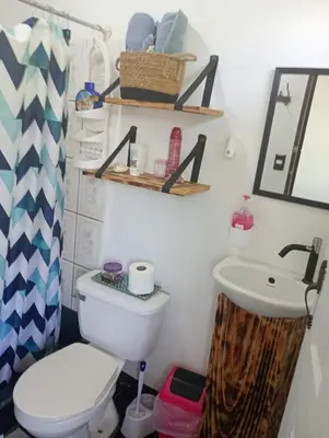 a bathroom with a toilet and a sink at Kristel Rooms in Quepos