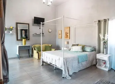 a bedroom with a canopy bed and a desk at Fruta mango # 1 in Playa Guacalillo